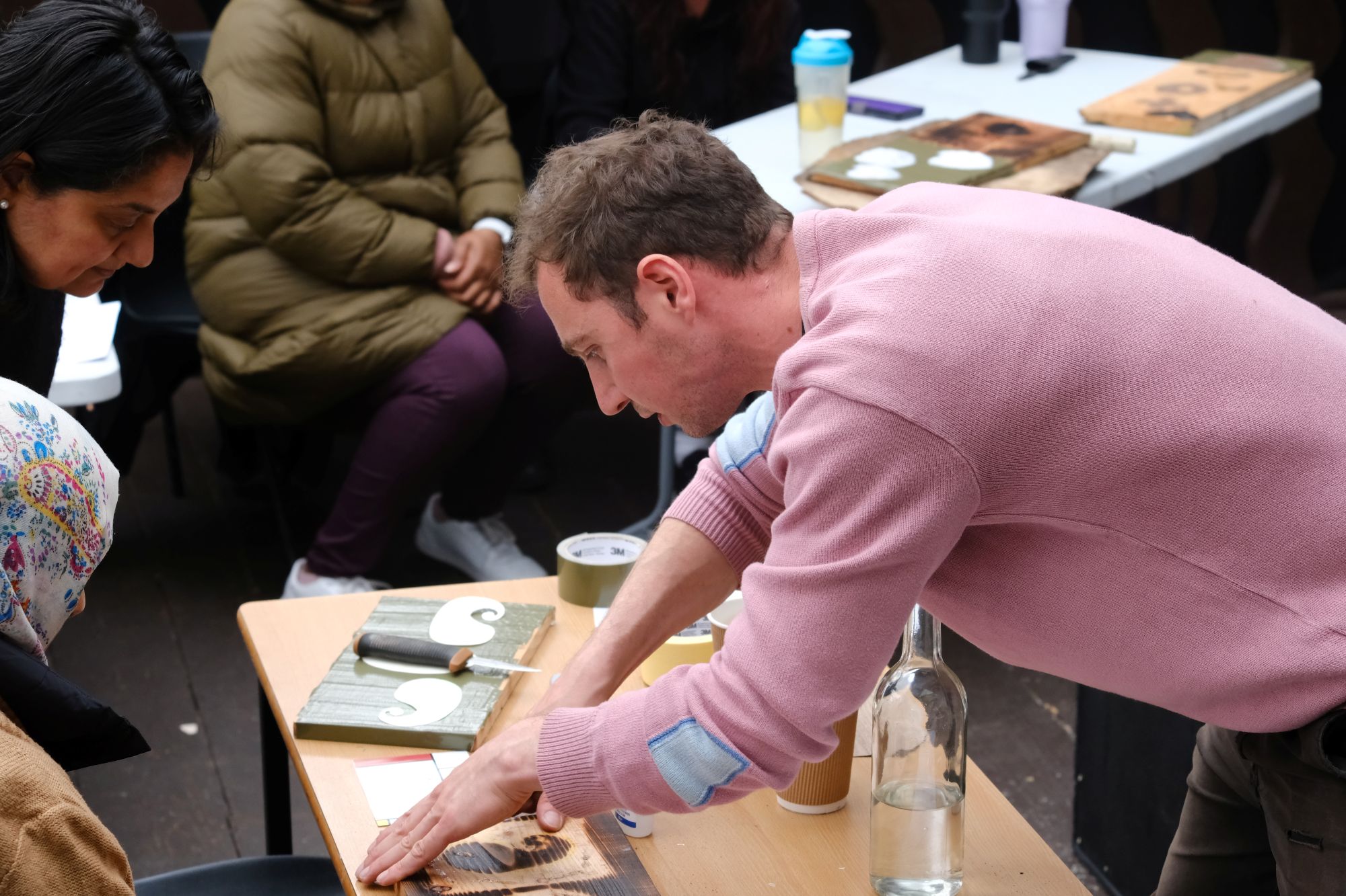 A photograph showing a group of Revoluton Arts participants at a workshop